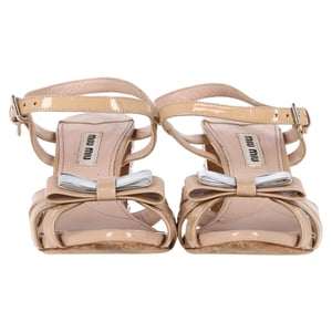 Miu Miu Sandalen mit Schleifendetail und Knöchelriemen in nudefarbenem Lackleder mit Kristallabsatz