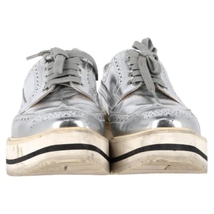 Prada Wingtip Oxford Plateau-Sneaker aus silberfarbenem Metallic-Leder