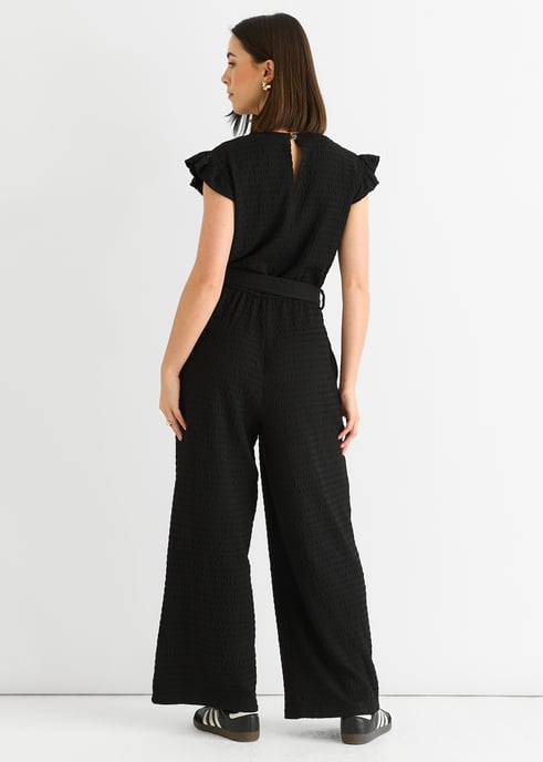 Schwarzer Jumpsuit mit elastischer Taille und Rüschen aus Stretch-Material - Image 4